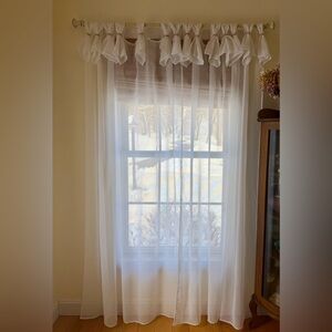 Sheer white curtain panels.